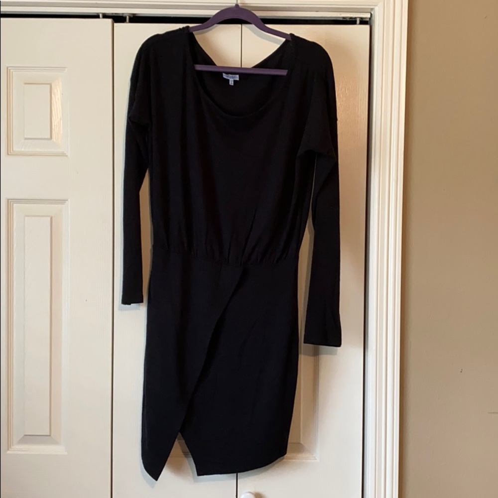 Black sweater dress with asymmetrical slit.